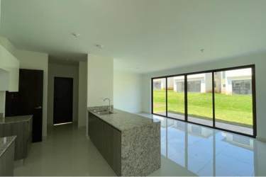 Kitchen with granite island open dining area large windows at Riverview Costa Verde Panama