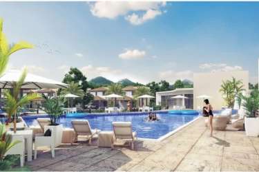 Outdoor lounge with large swimming pool, sun chairs, mountain backdrop at Riverview Costa Verde Panama Oeste