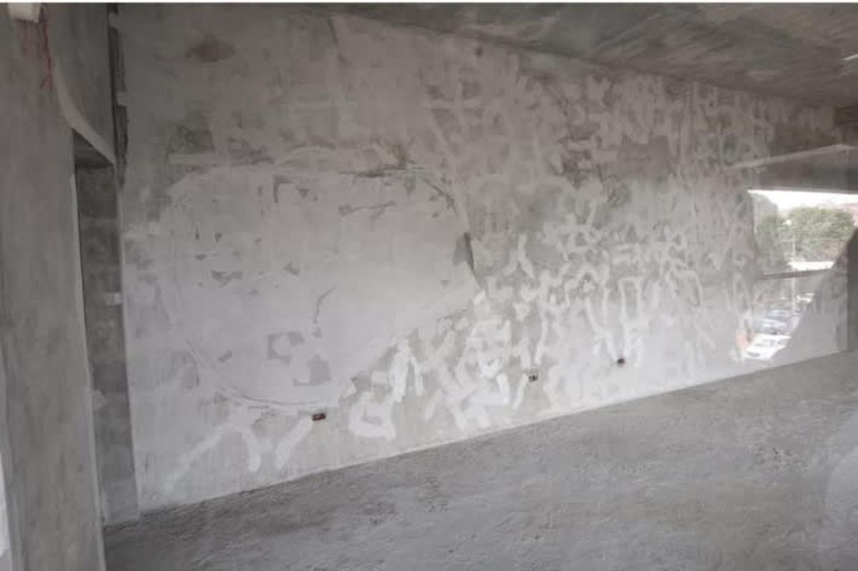 Gray shell empty commercial unit with concrete walls and large windows ready for tenant build out Greenwood District Panama