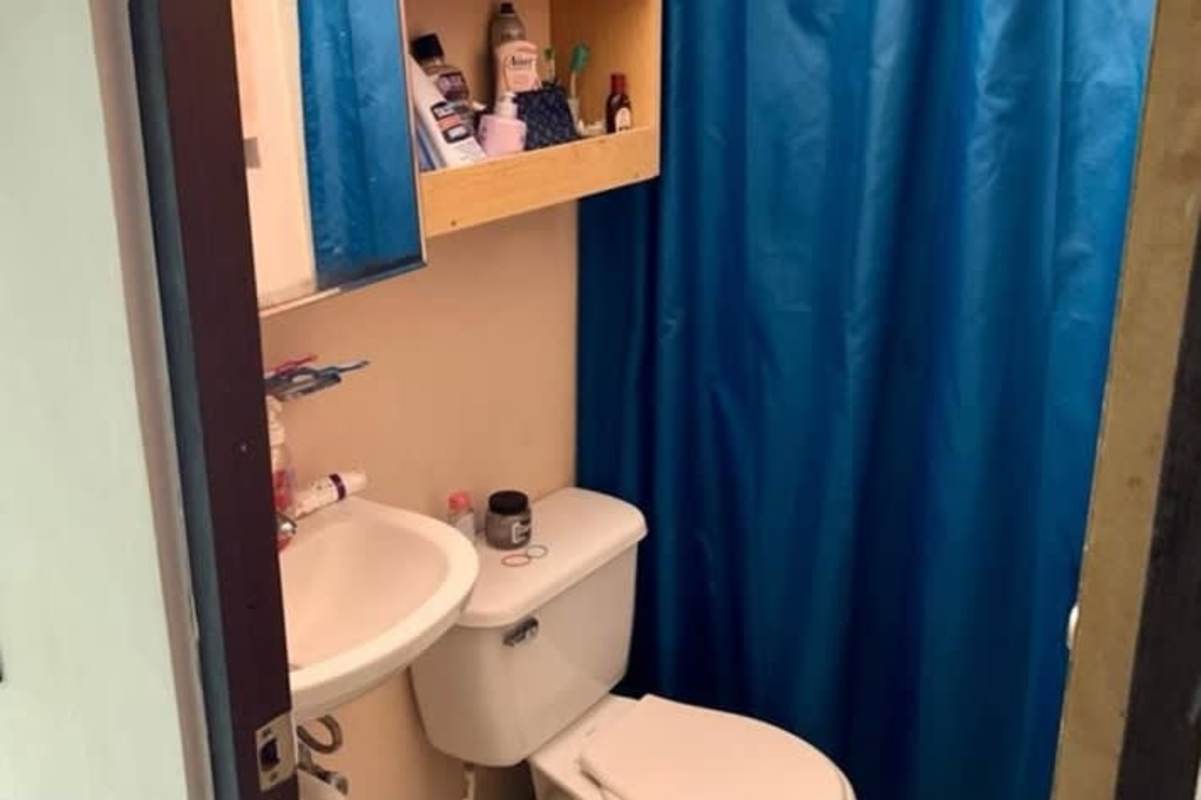 Compact bathroom with toilet sink mirror and blue shower curtain Tocumen house