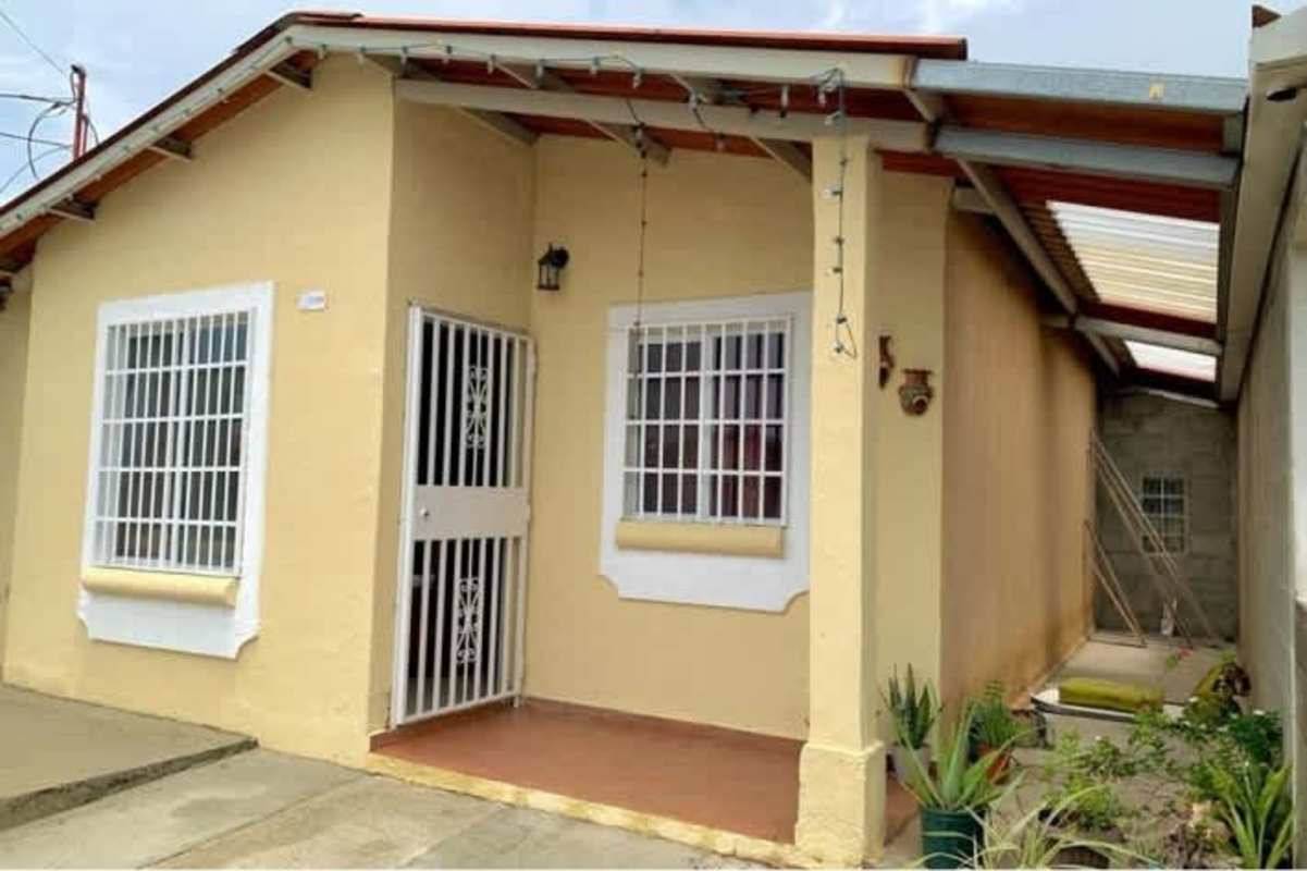 Small single-story house porch with potted plants Parque Villa Lucia Tocumen Panama