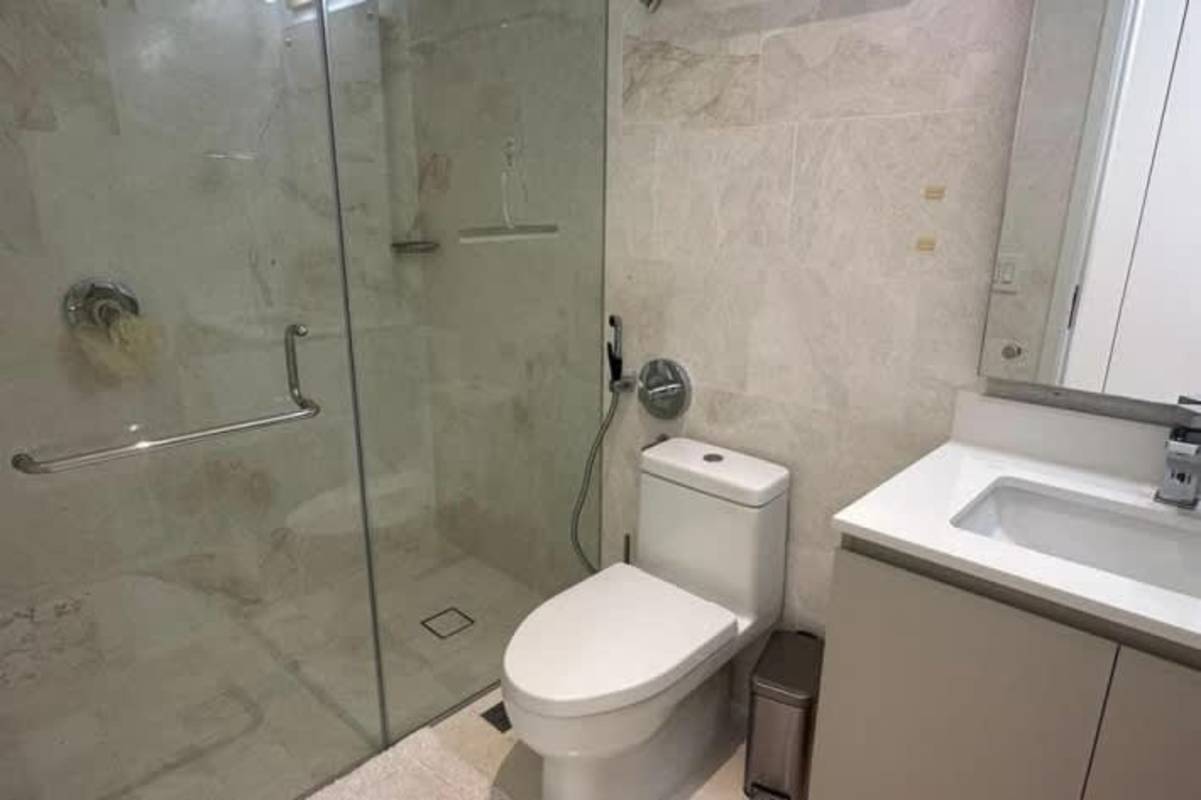 Upscale contemporary bathroom with double vanity, glass shower enclosure, large mirror and ocean view window at Ocean Reef Islands Panama
