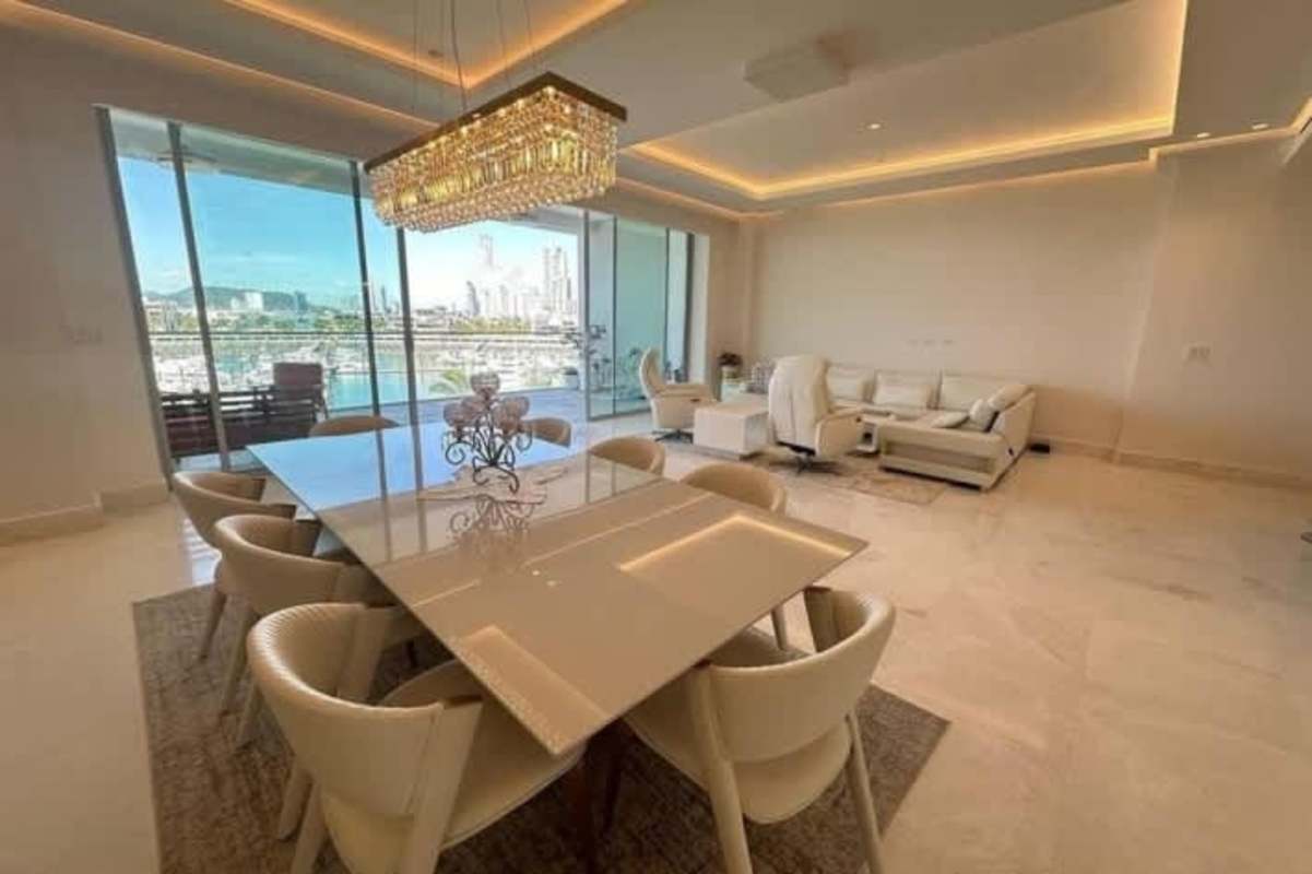 Modern kitchen with large island, pendant lights, stainless steel appliances in luxury apartment at Ocean Reef Islands Panama