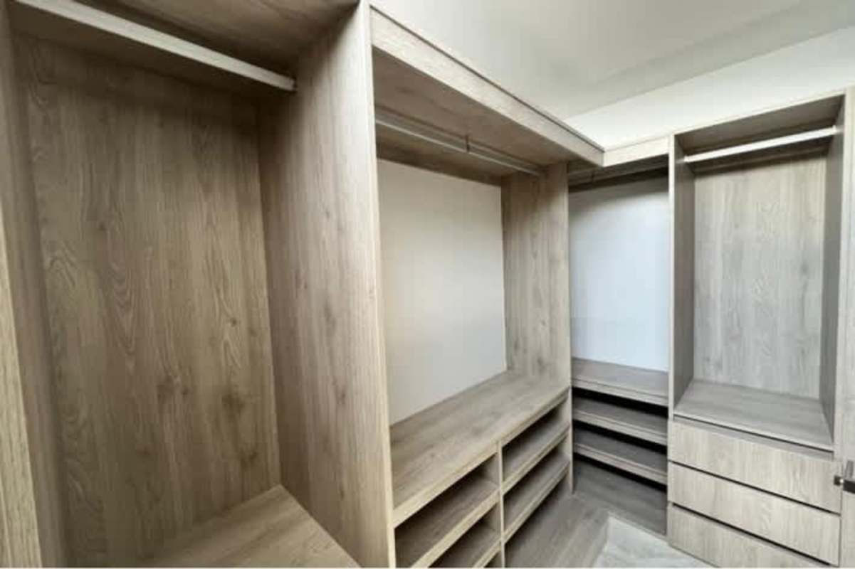 Spacious walk-in closet with custom wood shelving PH Luxor 400 El Cangrejo