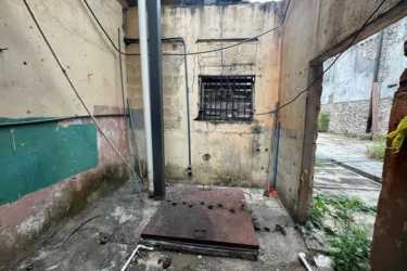 Unfinished storage space with piping, barred windows and concrete walls Casco Viejo Panama