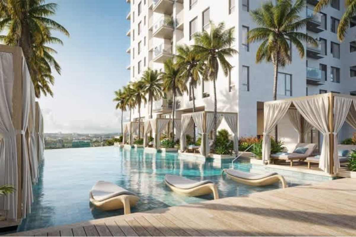 Resort-style infinity edge pool with shaded cabanas and lounge chairs Santa Maria Residences Panama