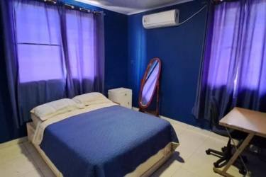 Traditional kitchen with black granite, white cabinets, window natural lighting Urbanización Maria Leticia Panama