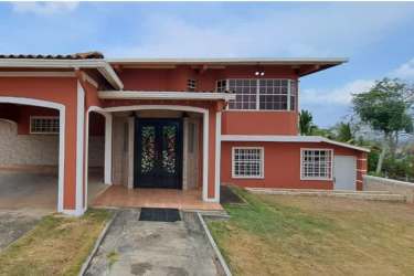 Living room with ample natural light, red sectional sofas, tile floors in house for sale Panama Oeste