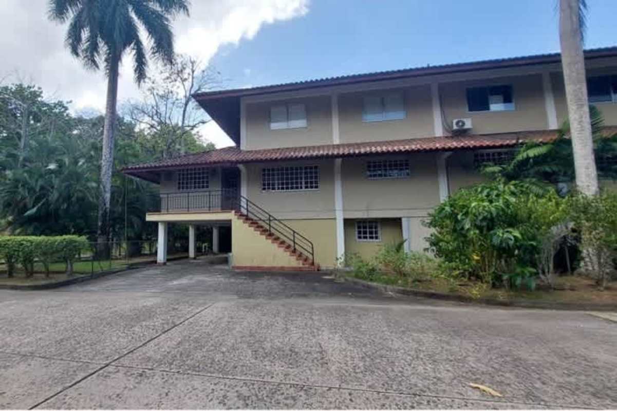 Exterior two-story house with clay tile roof and garden in Clayton Panama