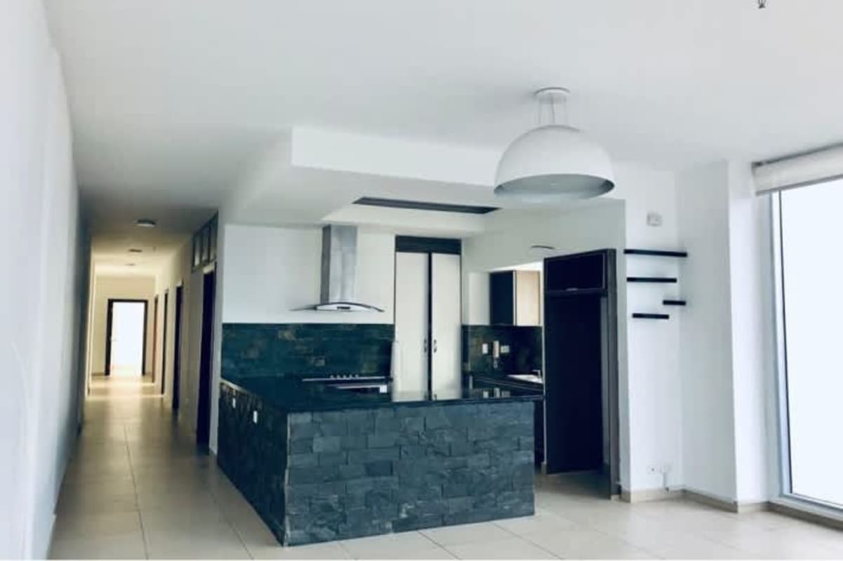 Kitchen with granite countertops and built-in appliances in PH Rivage apartment Panama