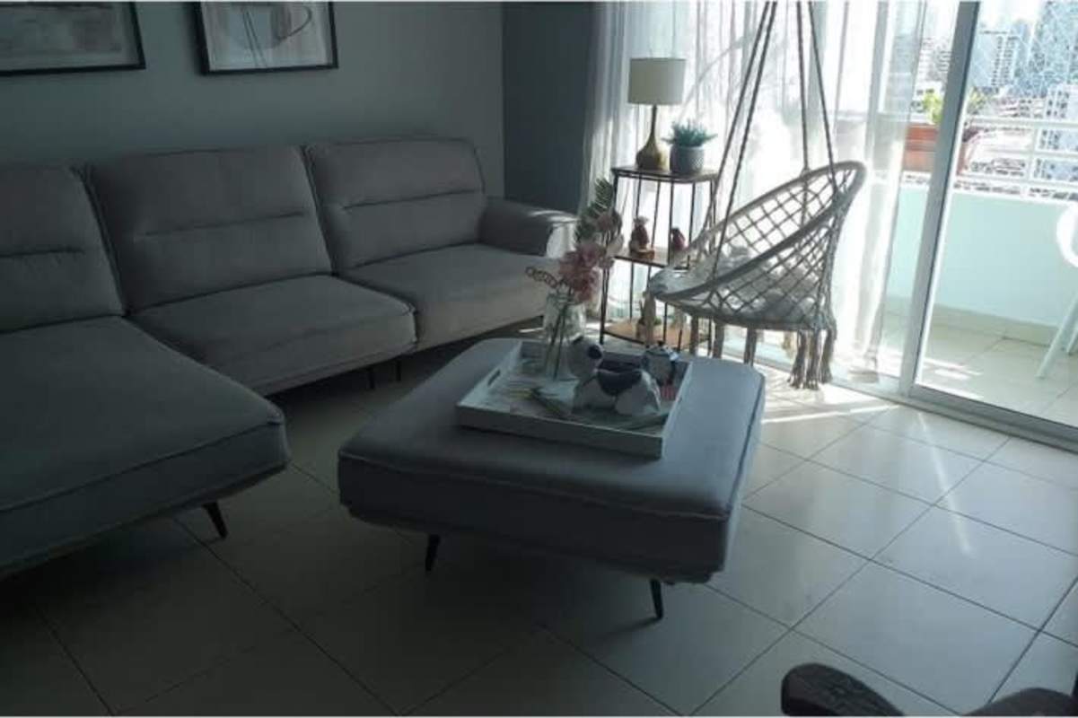 Spacious living room with gray sectional, hanging chair and balcony view PH San Francisco Bay Panama City