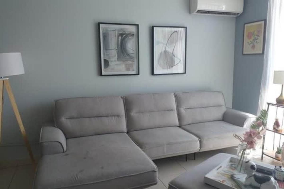 Bright furnished living room with gray sectional sofa, AC and decor in PH San Francisco Bay Panama City