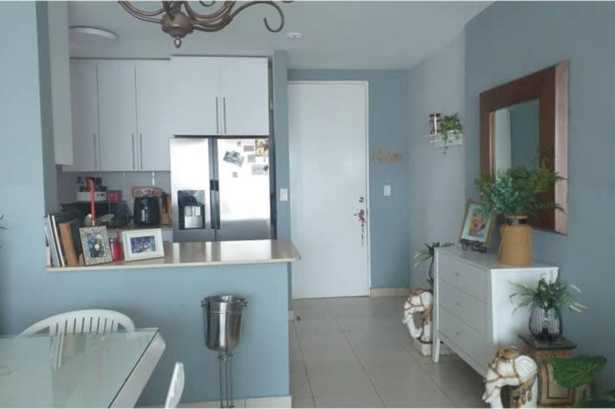 Sleek kitchen with stainless fridge, glass dining table and decor PH San Francisco Bay Panama