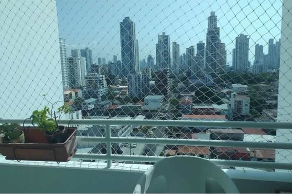 Living room with mounted flat-screen TV, traditional chairs and natural light PH San Francisco Bay Panama City
