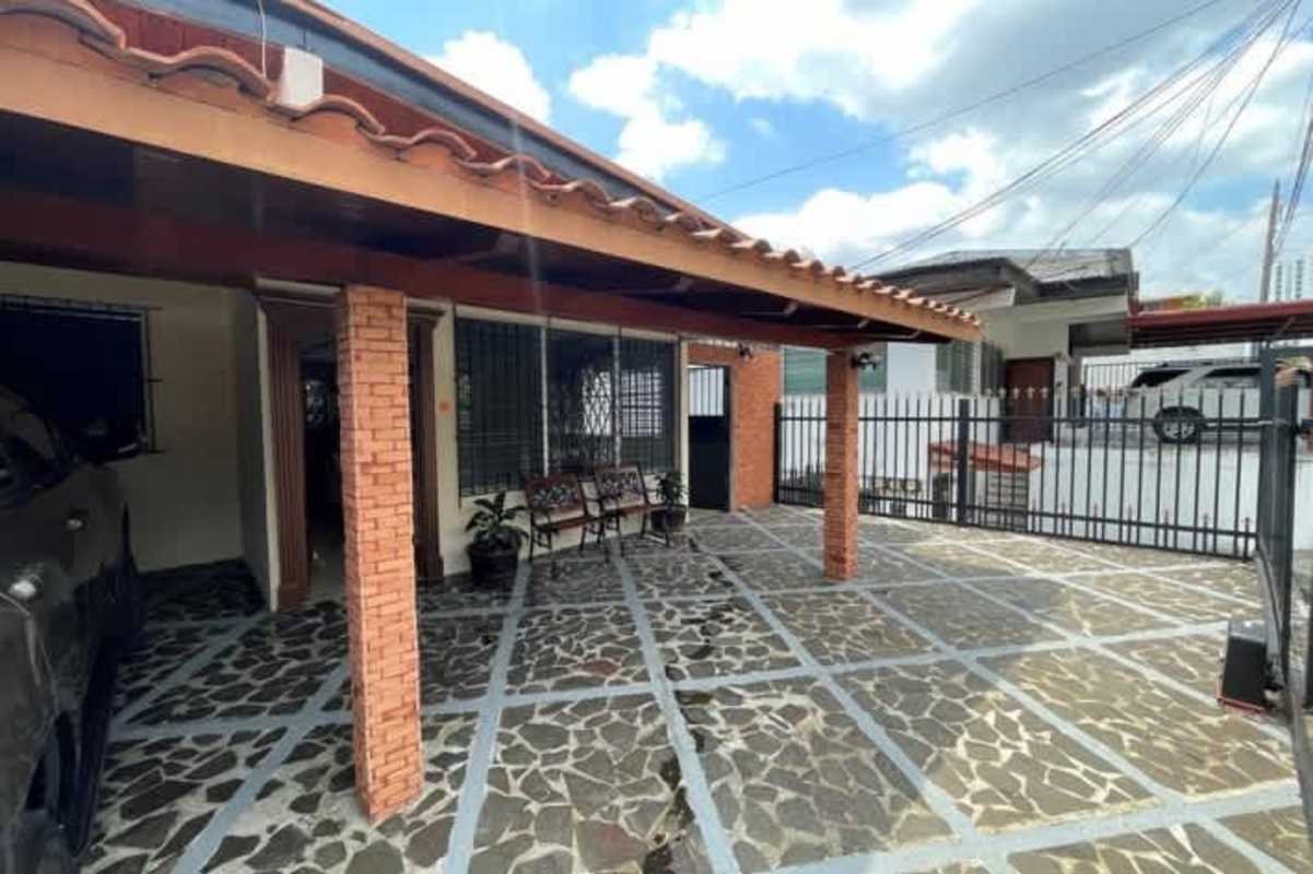 Driveway with gates and carport area of dual residence home for sale in Betania Panama City