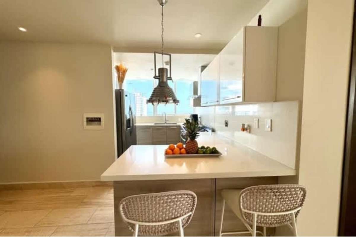Modern white kitchen with stainless appliances city skyline PH Oceana Tower Panama