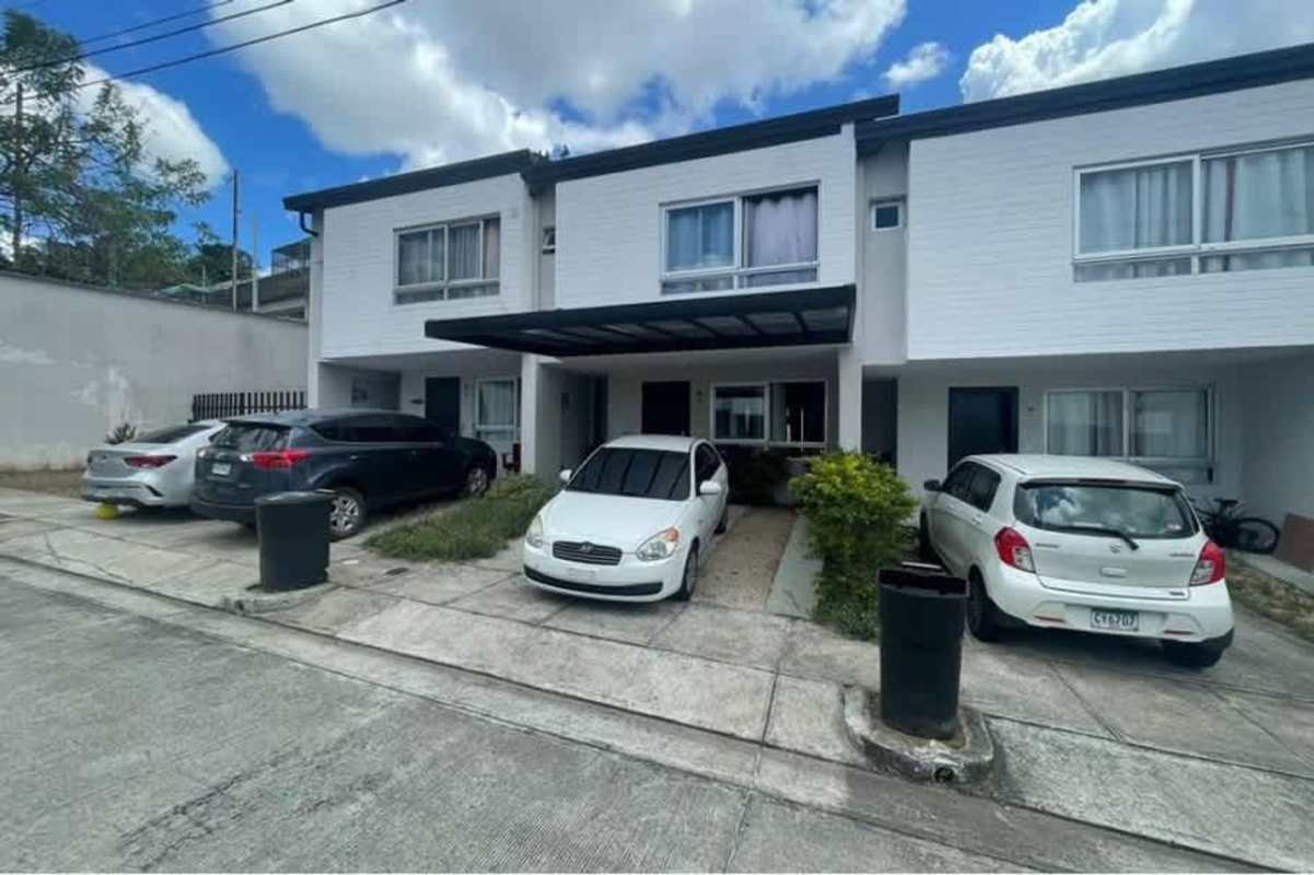 Modern townhouse facade with covered parking in Villasol El Crisol