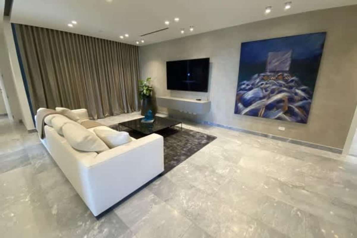 Modern kitchen with island, built-in appliances, minimalist cabinetry in luxury condo Costa del Este Panama