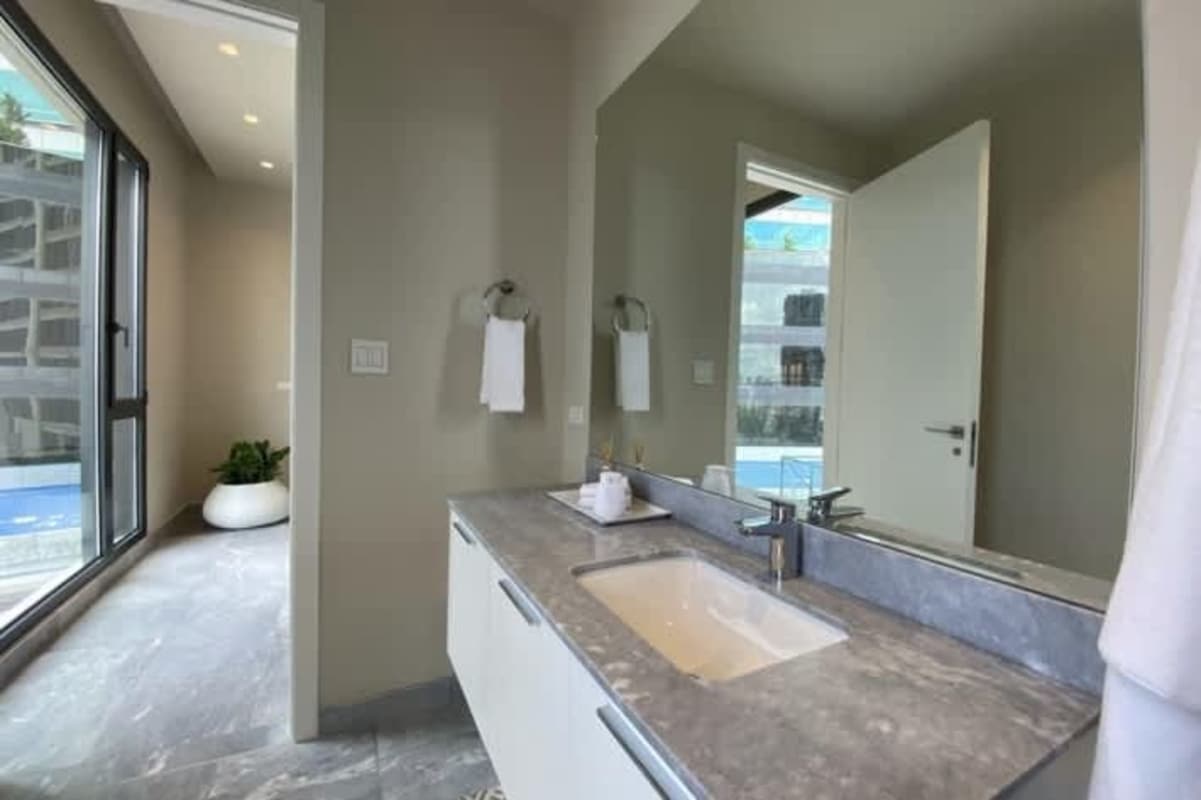 Luxury bathroom with spa bathtub, double vanity sink, glass shower Costa del Este Panama