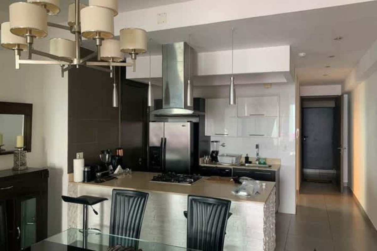 Open plan dining area and gourmet kitchen with modern finishes in luxury condo PH BICSA Tower Panama City