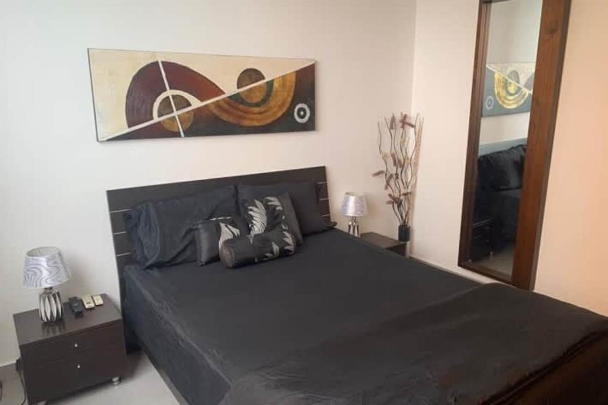 Bedroom with panoramic windows and ocean views in luxury furnished apartment PH BICSA Avenida Balboa Panama City