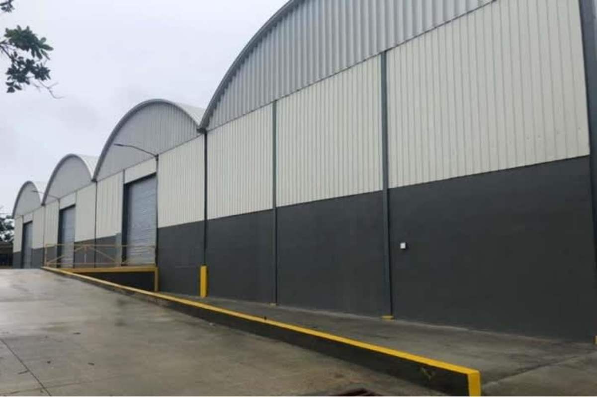 Row of industrial warehouses with roll-up storm doors and truck access in Altos de Tocumen Panama