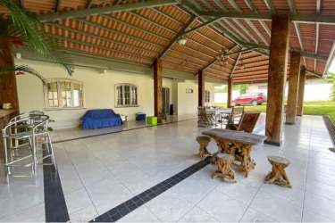 Ranch style house with red tile roof, large fenced yard, driveway, multiple parked vehicles in La Chorrera Panama