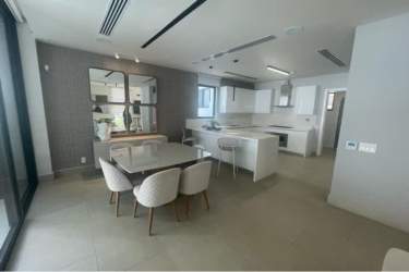Contemporary open-concept kitchen and dining area with large windows Panama Pacifico