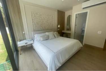 Comfortable guest bedroom with large window, ensuite bathroom in Panama Pacifico home