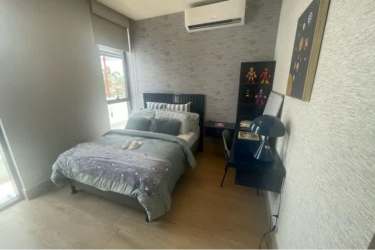 Primary bedroom with garden view, balcony, modern minimalist style at Panama Pacifico home