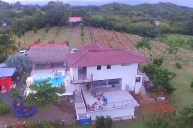 Tropical swimming pool with slide, hot tub, and palapa on large Panama farm Veraguas
