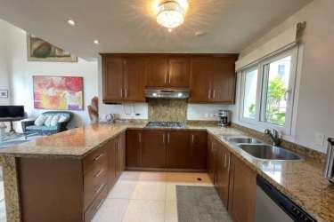 Spacious kitchen with granite countertops, wood cabinetry, stainless appliances in Tucan Country Club