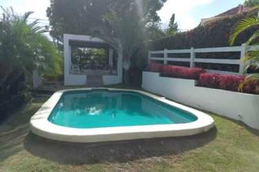 Private swimming pool with tropical garden and patio at Club Ecuestre Coronado