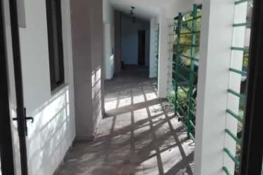 Hallway with tile flooring and white walls in Club Ecuestre Coronado home