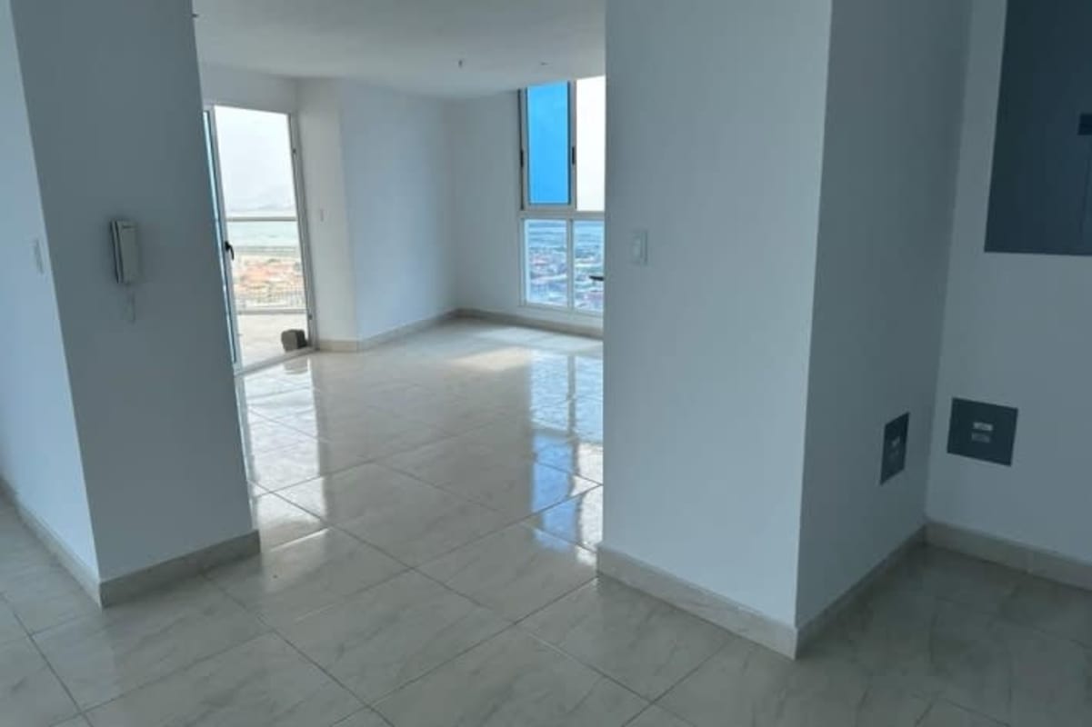 Bright living room with ocean view and access to balcony at The Sands on Avenida Balboa in Panama City