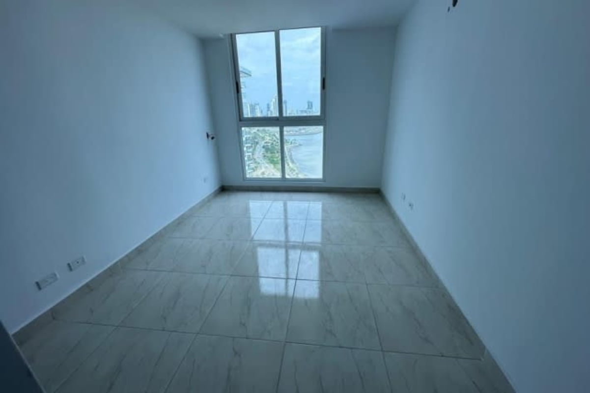 Unfurnished bedroom with large window and oceanfront view in The Sands Avenida Balboa Panama