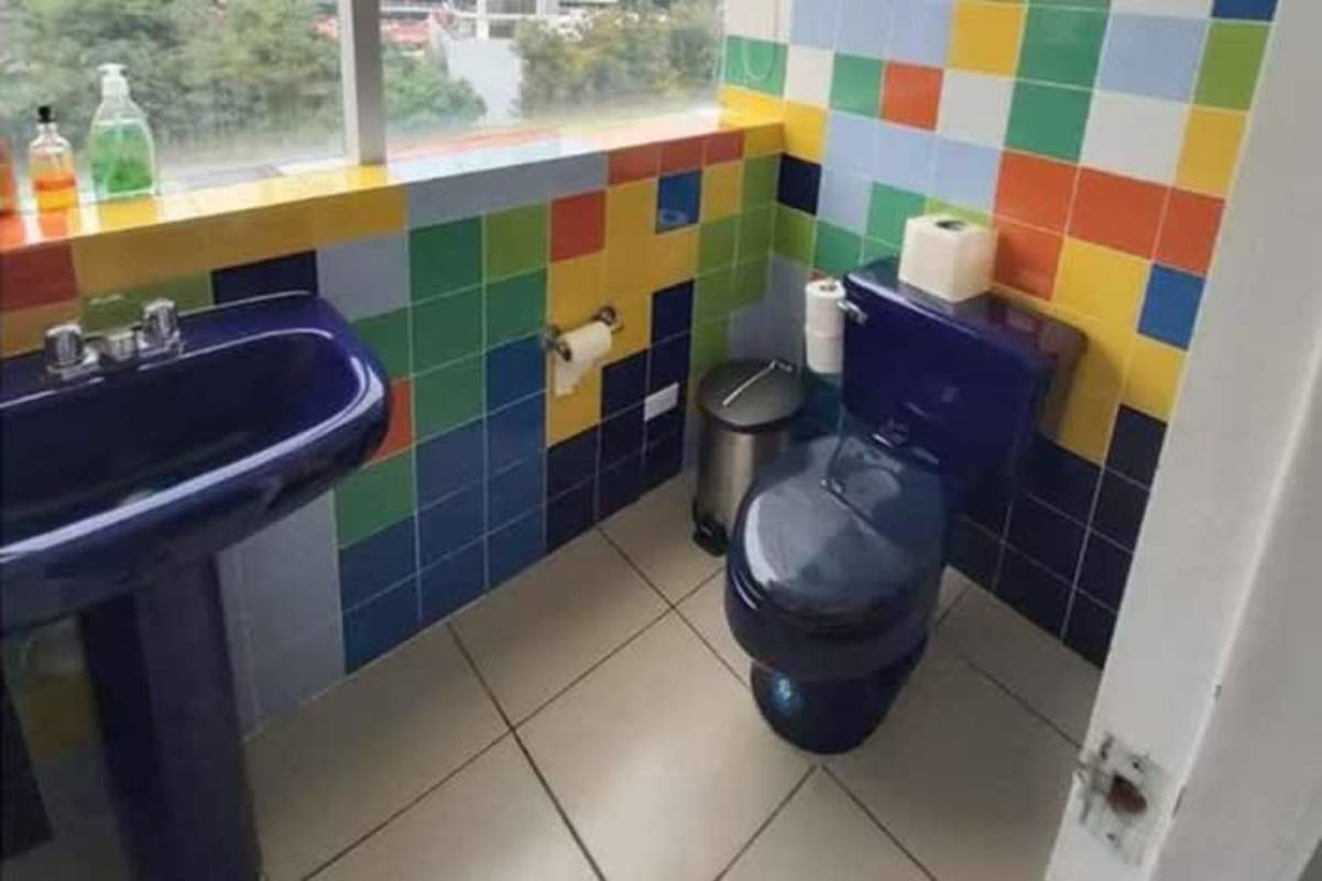 Bathroom with blue fixtures colorful mosaic tiles large window Hi-Tech Plaza Obarrio