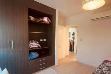 View of swimming pools and tropical landscaping from terrace at Bijao Beach Club Panama