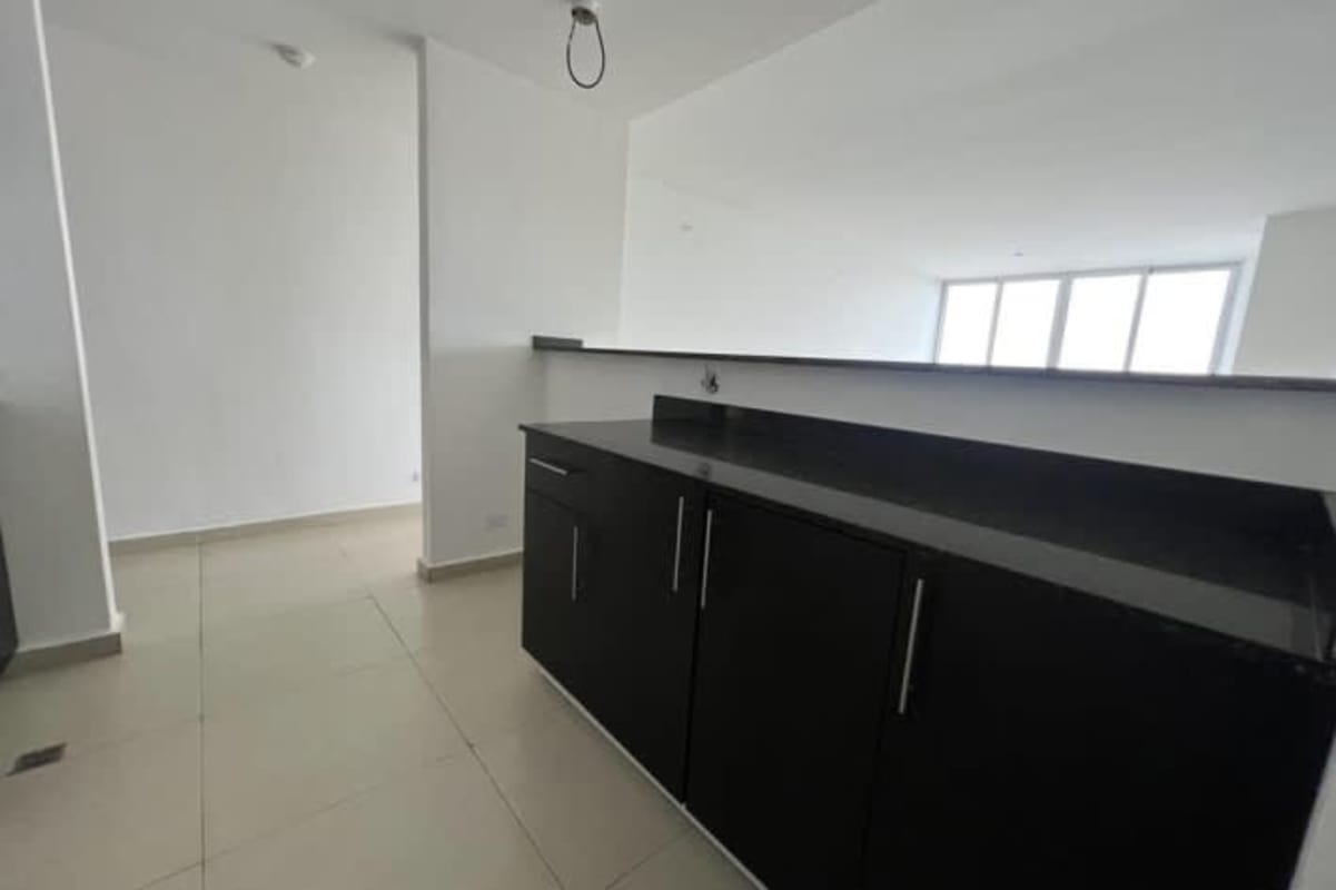 Kitchen with black granite counter, white walls and tile at Macedonia Towers Bethania Panama
