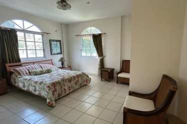 Grand foyer with high ceiling, marble floor, iron railings, large windows at Coronado mansion