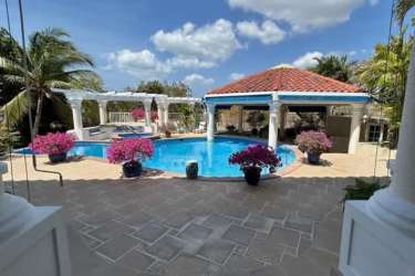 Luxury pool with gazebo, tropical gardens and lounge area in Coronado mansion Panama