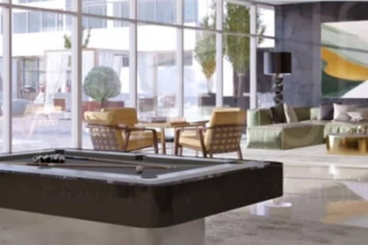 Contemporary lounge game room with pool table, modern art, floor-to-ceiling windows at Oceana Santa María