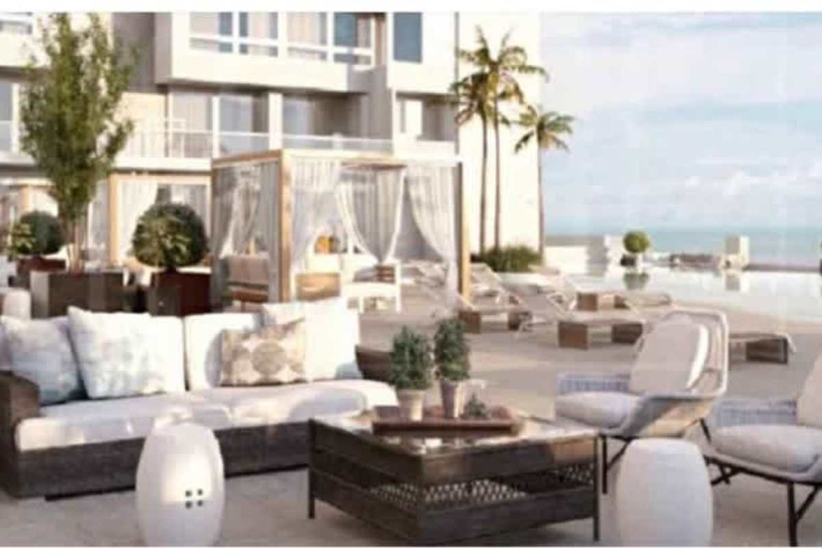 Luxury infinity pool area with cabanas, ocean view and palm trees in Santa María Panama City