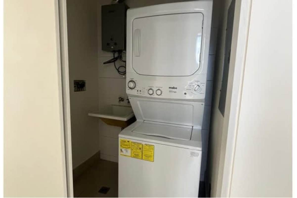 Compact modern laundry with washer dryer utility sink at PH Coco Skyline Coco del Mar Panama