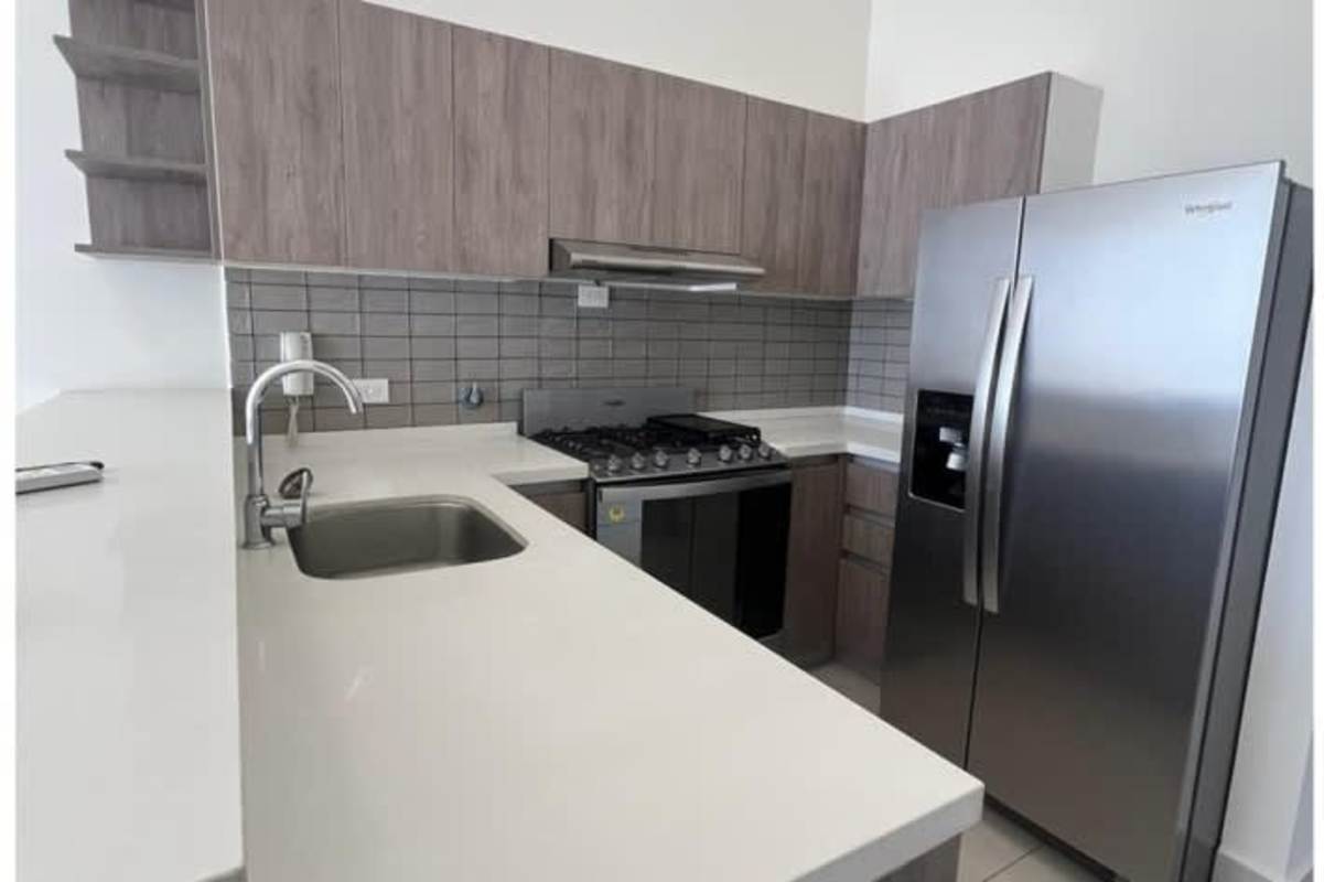 Kitchen equipped with stainless appliances quartz counters gray backsplash PH Coco Skyline Coco del Mar Panama