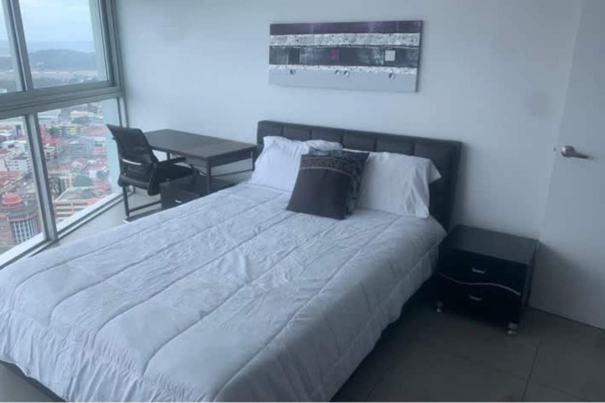 Dining area with glass table adjacent to open kitchen at Yacht Club Tower Panama