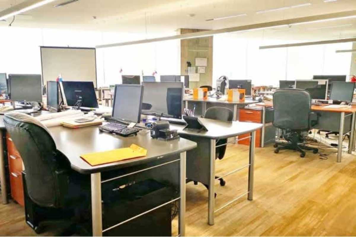 Open plan commercial workspace with large windows overlooking ocean and city in PH BICSA Tower Panama