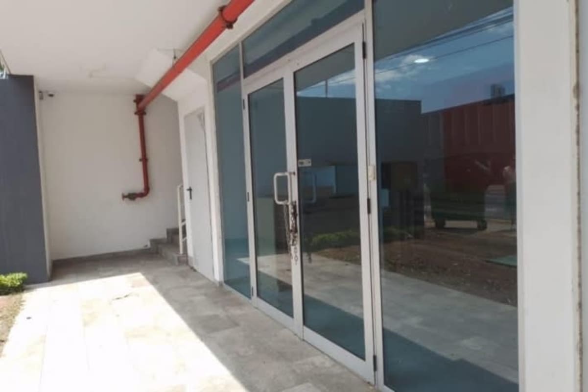 Exterior view of Signature Point Tower glass facade commercial entrance Bella Vista Panama City