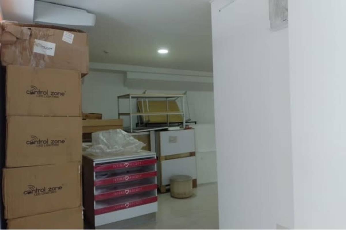 Utilitarian storage room stacked boxes shelves air conditioning at Signature Point Panama City