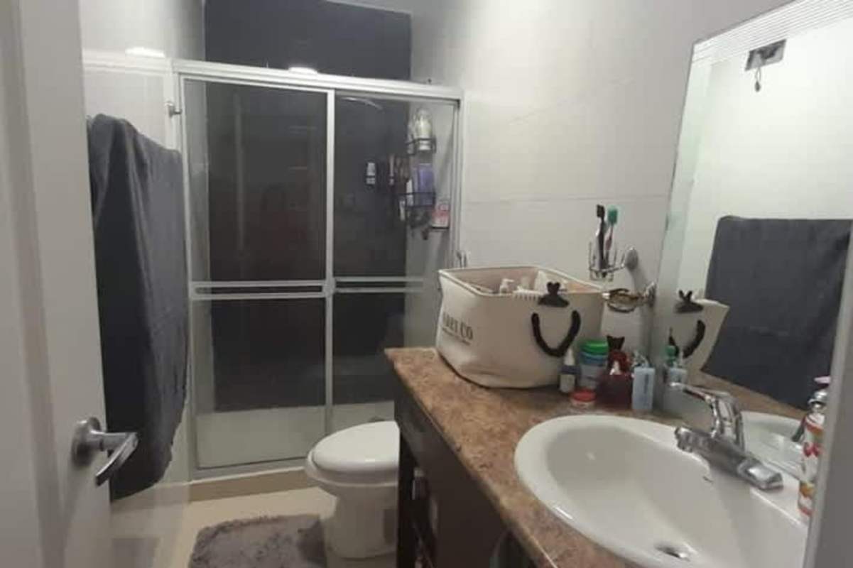 Modern bathroom with glass shower enclosure and vanity in Hill Tower Dos Mares Panama City